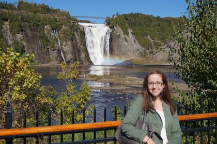 Stephanie standing in front of a waterfall