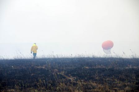 A researcher takes measurements using an aerial sampling system.