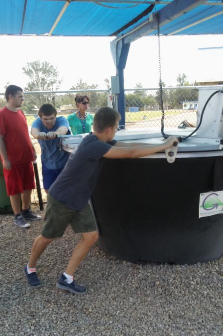 This is a picture of students turning a compost pile