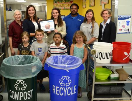 Students and staff from Shawnee mission school district behind compost, recycle, liquids and silverware bins