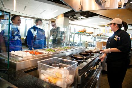 This is a picture of some students in the buffet line in one of UMass Lowell's dining halls.