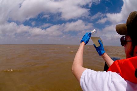 EPA researcher collecting water samples in the Gulf of Mexico