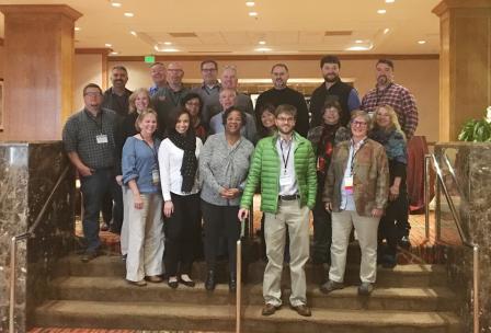 Photograph showing the Federal Facilities Forum members standing in a room.