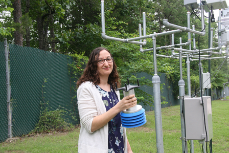 EPA Scientist Ingrid George holds an SPod, a fenceline monitoring system developed by EPA that can identify air pollution plumes from leaks or other fugitive emissions at the perimeter of an industrial facilities.  