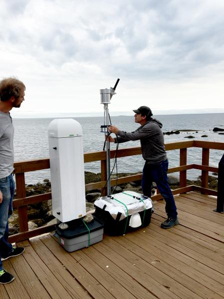 David Williams and Luke Valin (from NERL) at the U.S. Fish and Wildlife Service Outer Island, CT site. Dave is installing a spectrometer and the large white instrument is a ceilometer.