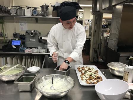 This is a picture of a chef at Boston College preparing a meal
