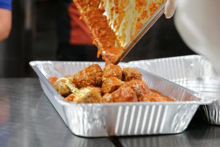 this is a picture of food being put into a to go container