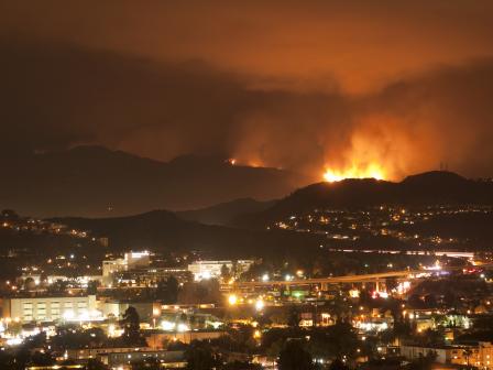 Image of wildfires near structures in Los Angelos, CA