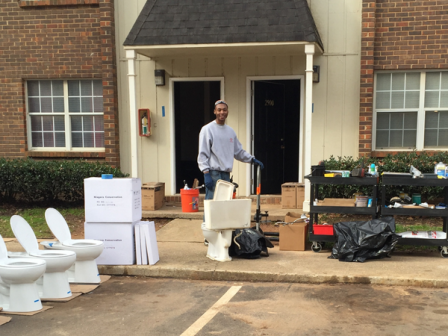 Man getting ready to install water efficient toilets in an apartment building.