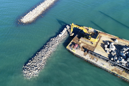 Photo of A barge places rocks along a berm constructed to reduce erosion and provide additional spawning habitat within the Detroit RI AOC. Photo Credit: Friends of the Detroit River