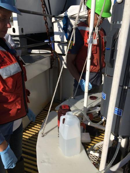 phtoto of Scientists collect raw water samples from the Rosette's Niskin bottles while onboard the R/V Lake Guardian.