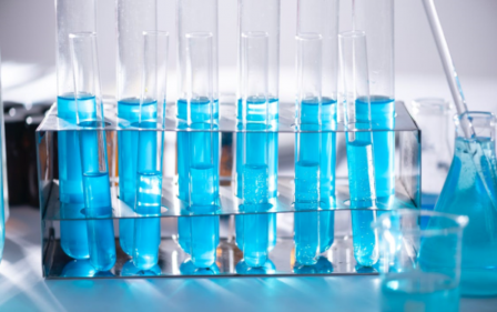 Photograph of a series of test tubes, filled with blue liquid