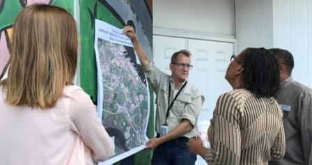 A group of EPA researchers and community members review a map of a port