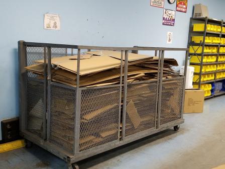 This is a picture of a cage full of flattened cardboard.