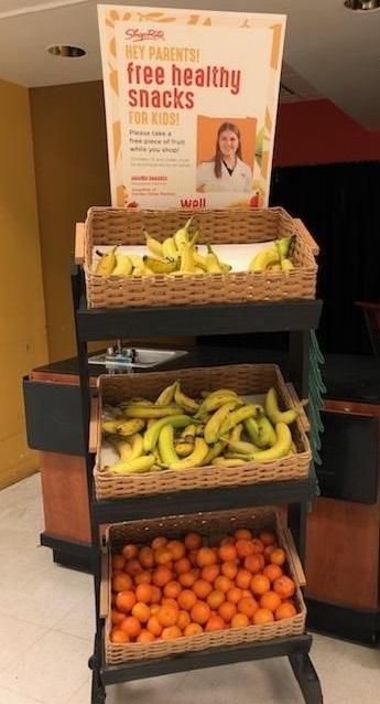 This is a picture of a stack of baskets with bananas and oranges in it.