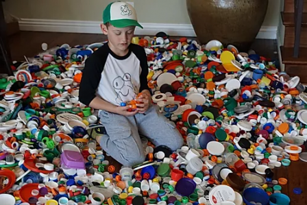 Justin Sather with a collection of plastic caps he encouraged his community to save. 