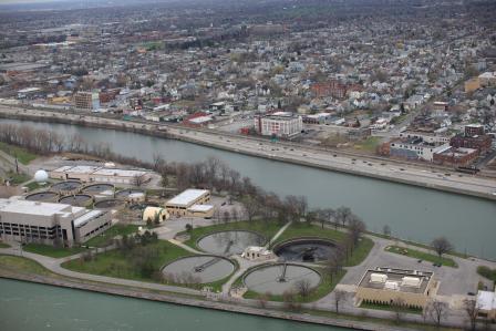 photo of An aerial photo shows the Black Rock Canal between unity island and the sewage treatment plant in the foreground and the City of Buffalo in the background.