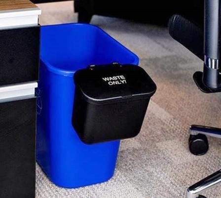 Blue plastic under desk recycling bin with small black plastic bin attached on one end for collecting trash.