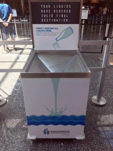 Large rectangular metal bin with sloped interior where airport travelers can dump out liquids before security screening.