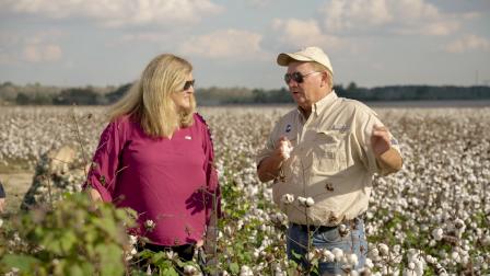 photo of Dunn and a man outstanding in his field