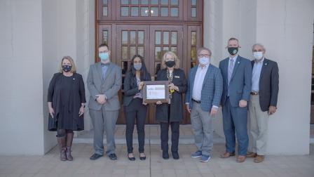 6 people standing with Wheeler, all in masks