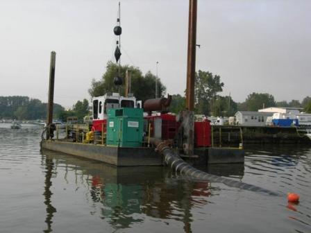 photo of  Hydraulic dredging removes contaminated sediment in the Ottawa River. The black tube is used to move contaminated sediment to the landfill where geotubes were filled. Photo credit: Ohio EPA