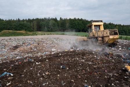 A compactor vehicle in a landfill