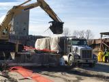 Loading asbestos material onto a truck for proper disposal. 