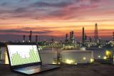 Stock photo showing a laptop computer with a refinery in the background - also a link to the CMAQ Models page