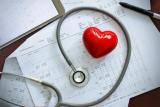 Heart and stethoscope on top of papers
