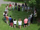Kids stand in a circle learning a lesson about the environment