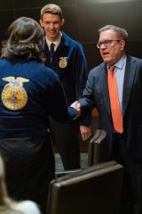 Acting Administrator Wheeler shakes hands with a FFA member as another looks on