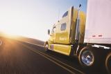 Decorative image of a yellow heavy-duty tractor on a road.