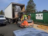 Loading electronic waste into truck trailer for off-site disposal from BERI