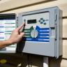 Hand pressing an irrigation controller